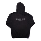 Back view of Sauce Bae black hoodie with 'Sauce Bae MMXVII' text in white. Classic design with a modern touch, representing the brand's establishment year.