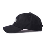 Side view of black dad hat with white embroidered 'Sauce Bae' logo on the front. Perfect for fans of Sauce Bae, a health-focused hot sauce and raw honey brand.
