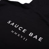Back view of Sauce Bae black hoodie with 'Sauce Bae MMXVII' text in white. Classic design with a modern touch, representing the brand's establishment year.